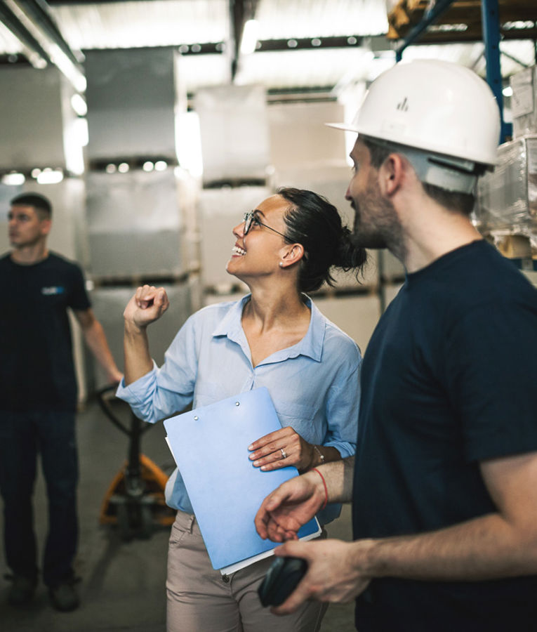 Construction team using intelligent solutions on a digital tablet to optimize workforce scheduling and efficiency.