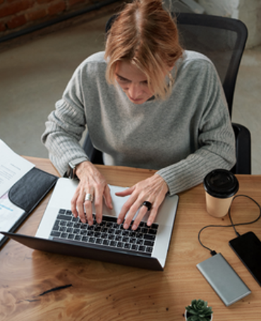 Employee uses time tracking on a laptop to measure and analyse actual working time.