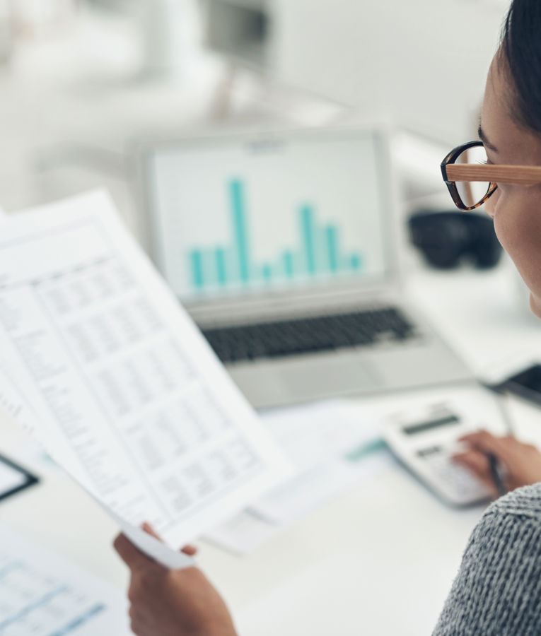 HR professional analysing reports and data charts on a laptop as part of workforce management, HR controlling, staff scheduling and time tracking