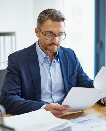 Business professional analysing workforce reports and schedules, focusing on compliance, labour costs, and strategic planning.